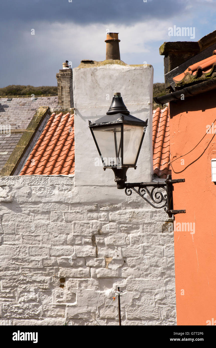 UK, England, Yorkshire, Staithes, old fashioned street lamp amongst lower village houses Stock Photo