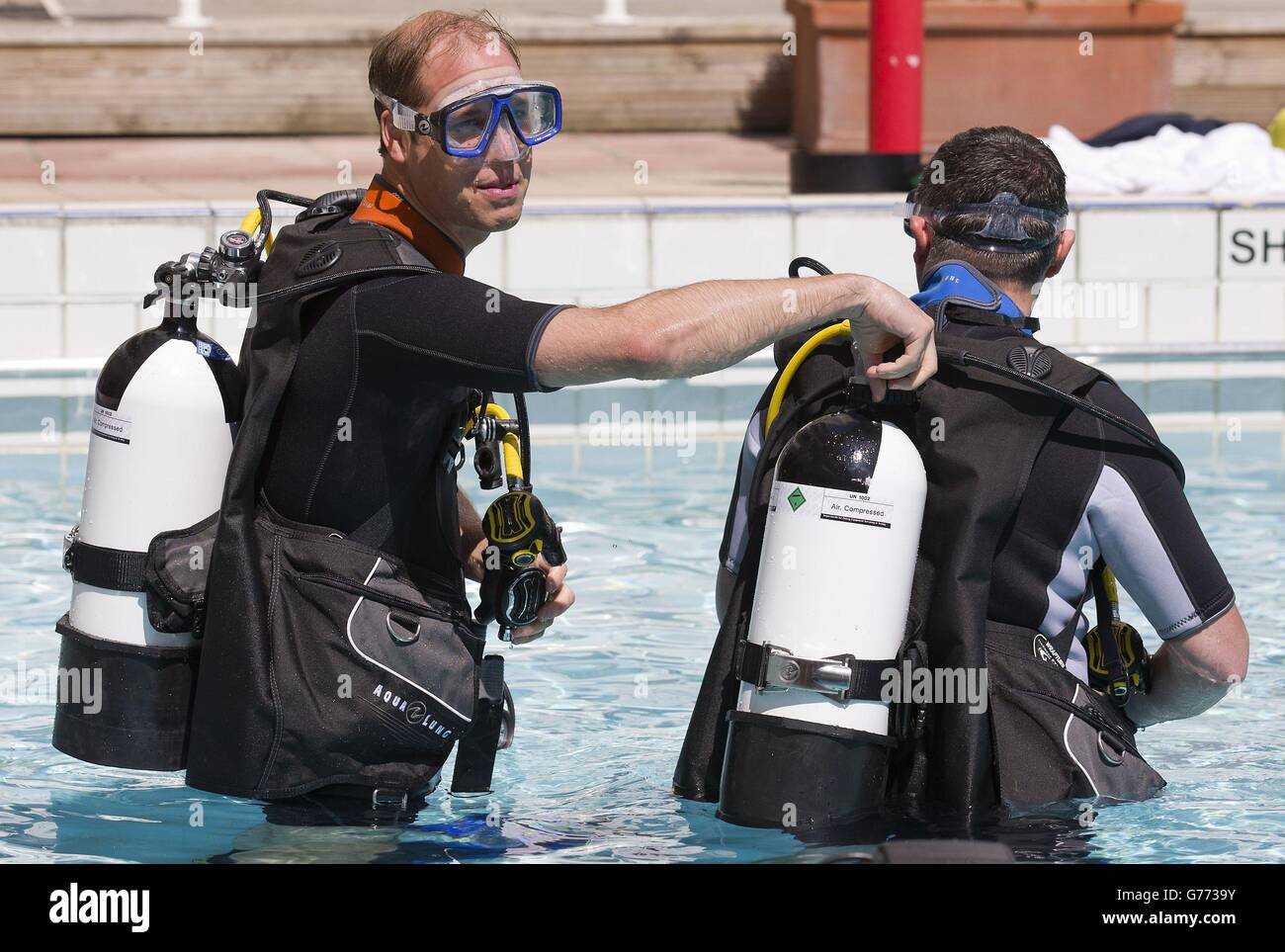 The Duke of Cambridge makes safety checks with BSAC Chairman Eugene Farrell before scuba diving with British Sub-Aqua Club (BSAC) members at a swimming pool in London. Stock Photo