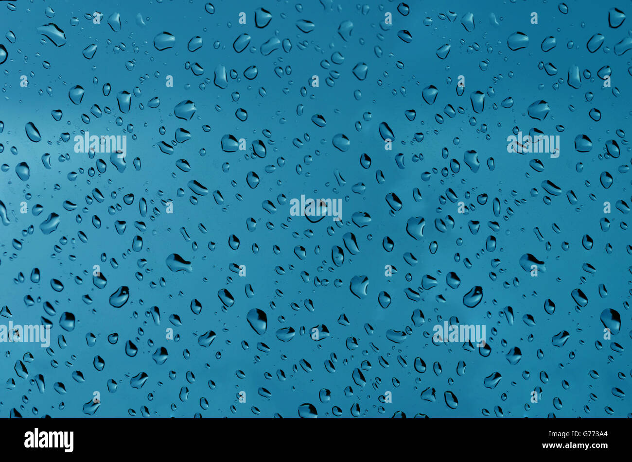 Water droplets on the glass with a colored background. Drops of water. Stock Photo