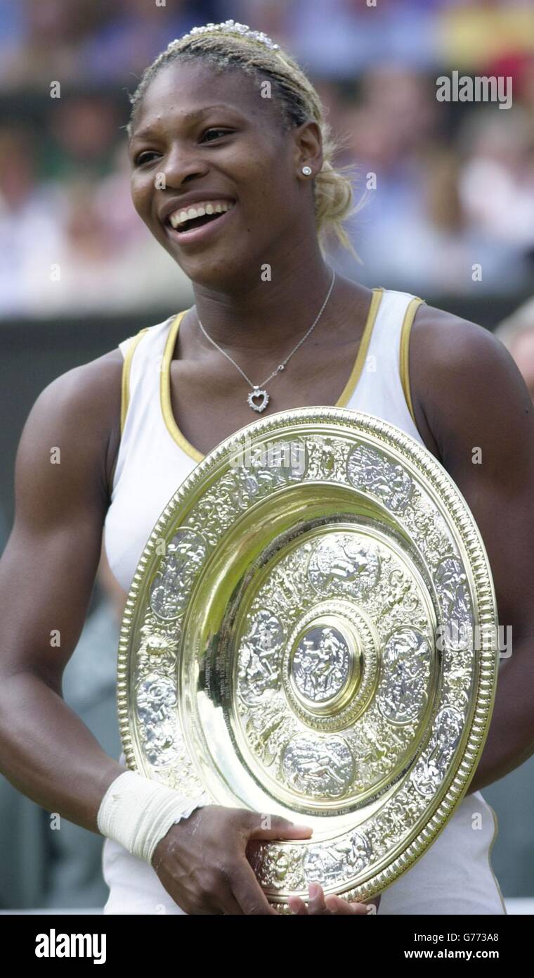 , NO COMMERCIAL USE. Serena Williams from the USA holds her trophy after beating her sister Venus in the Ladies' Singles Final at Wimbledon. It is the first time in 118 years that sisters have met in the final at Wimbledon. Serena triumphed in straight sets 7:6/6:3. Stock Photo