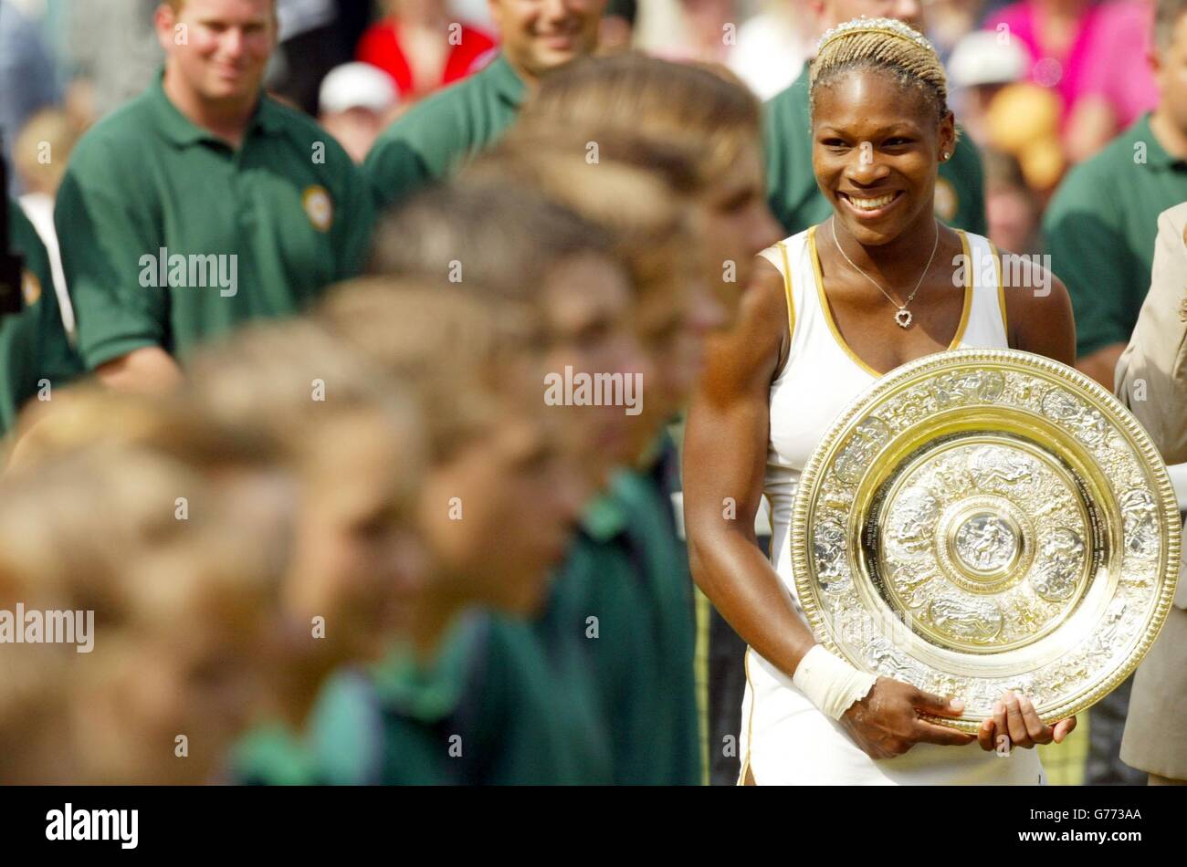 EDITORIAL USE ONLY, NO COMMERCIAL USE. Serena Williams from the USA holds her trophy after beating her sister Venus in the Ladies' Singles Final at Wimbledon. It is the first time in 118 years that sisters have met in the final at Wimbledon. Serena triumphed in straight sets 7:6/6:3. Stock Photo
