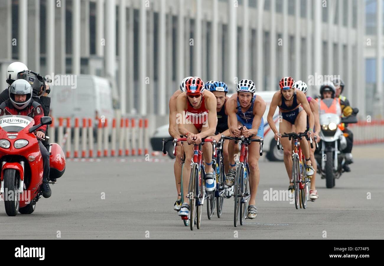 Elite men's cycle group led by Stuart Hayes as they enter the final lap during the London Triathlon at Royal Victoria Docks. Stock Photo