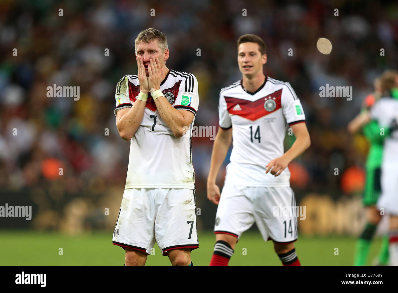 Germany's Bastian Schweinsteiger shows his emotions at the final whistle as teammate Julian Draxler (right) looks on Stock Photo