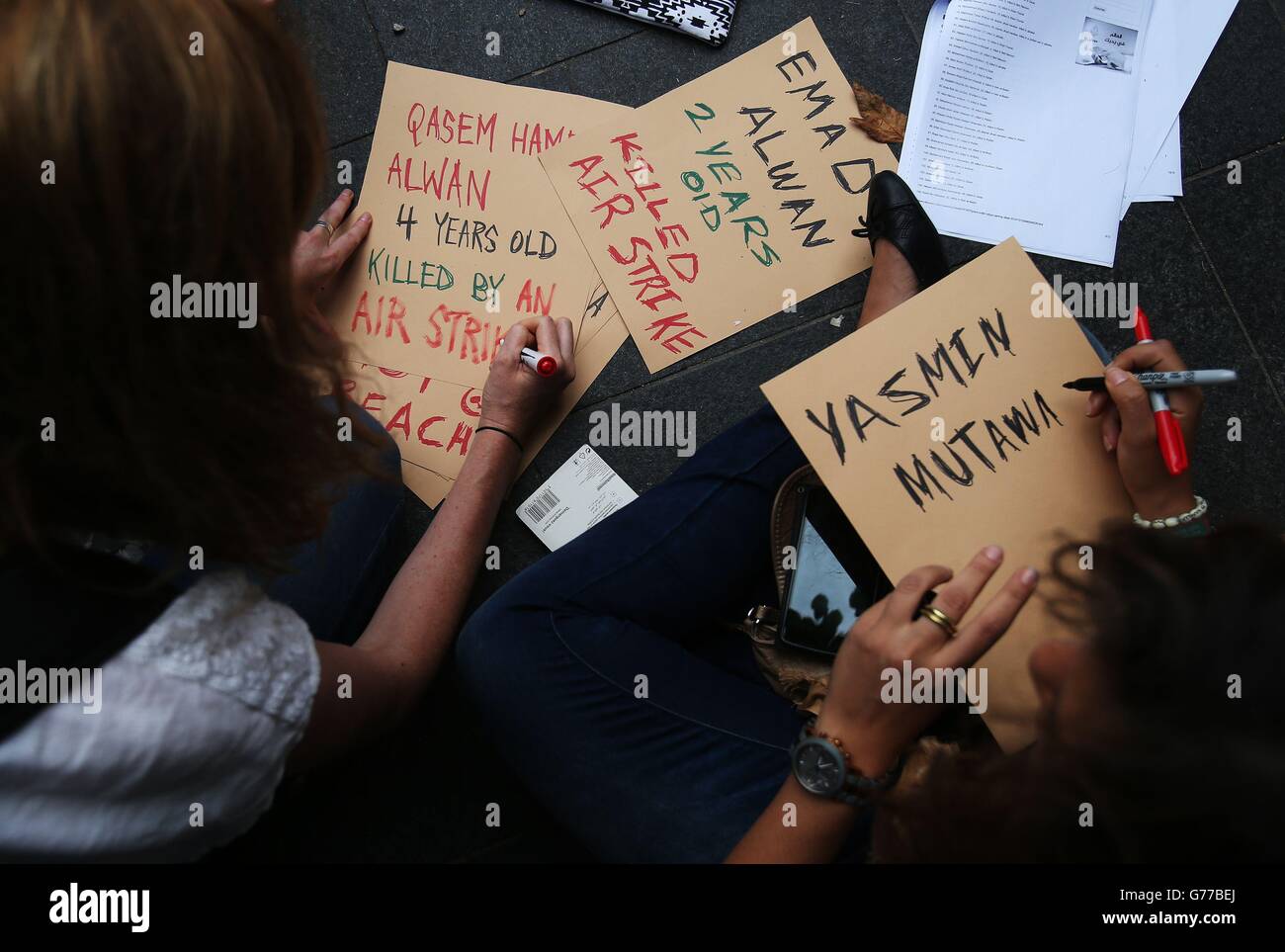 People write placards ahead of a protest march through Dublin city centre to call for an end to Israeli military action in Gaza and 'justice and freedom' for Palestine. Stock Photo