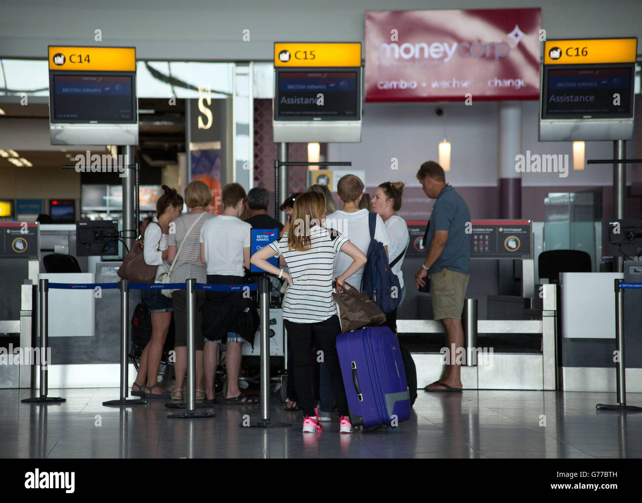 Passengers queues to drop their bags off as they checkin for their
