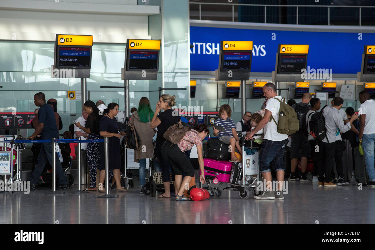 Passengers queues to drop their bags off as they checkin for their