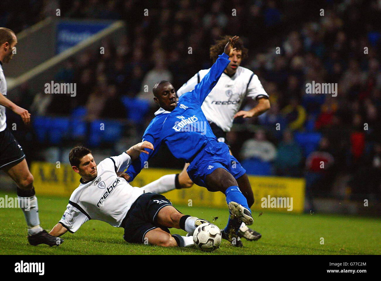 Chelsea's Jimmy-Floyd Hasselbaink (centre right) is tackled by Bolton Wanderers Anthony Barness during their FA Barclaycard Premiership match against Chelsea at Bolton's Reebok Stadium ground in Bolton. Bolton Wanderers drew 1-1 with Chelsea. Stock Photo