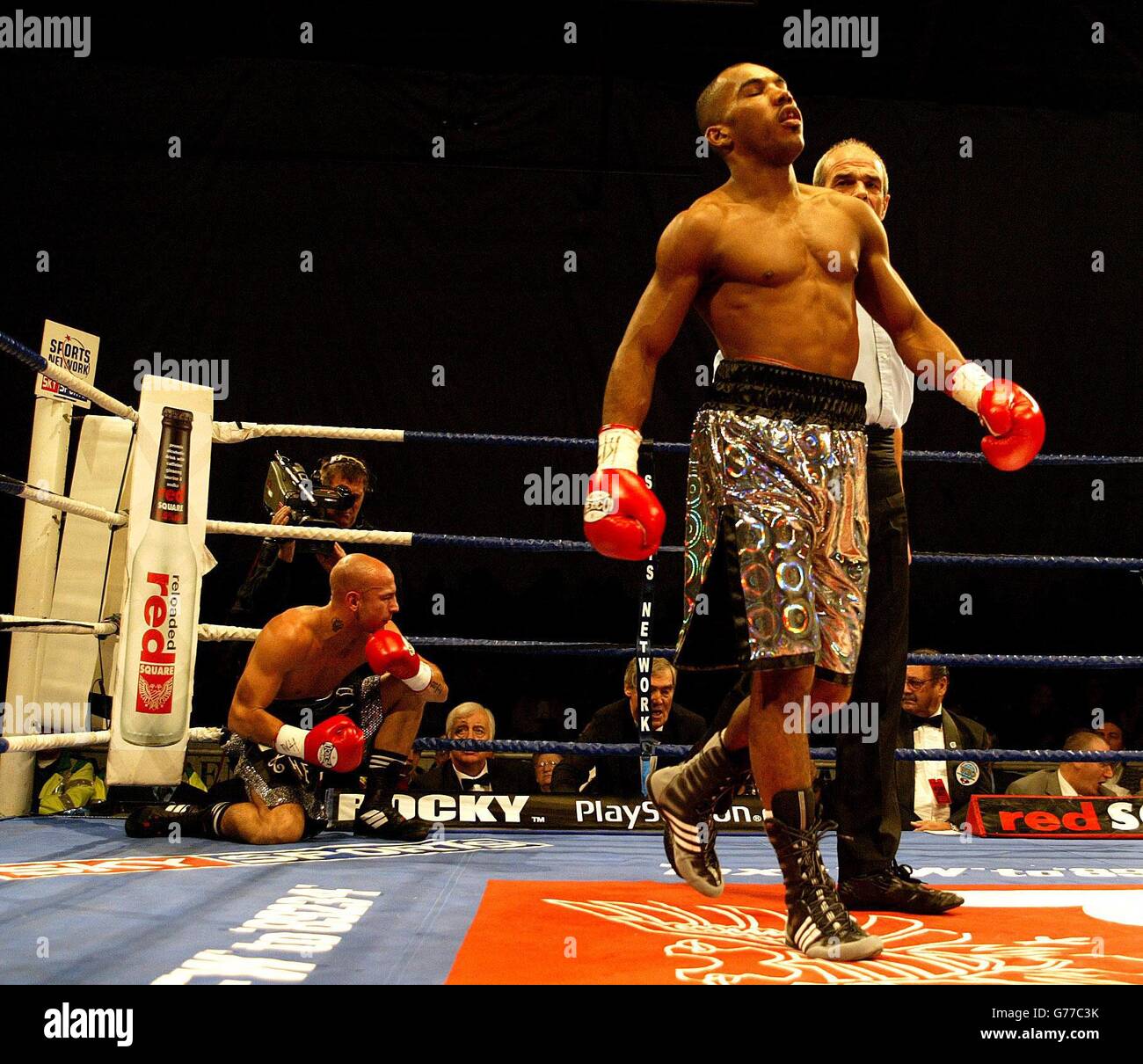 Junior Witter (right) goes to a neutral corner, as challenger Guiseppe Lauri (left), recovers after a 1st round knockdown. Witter beat Lauri in the 2nd round, stoped by referee Micky Vann, during Official eliminator contest for the WBO Light-Welterweight Championship of the World, at Storm Arena in Derby. Stock Photo