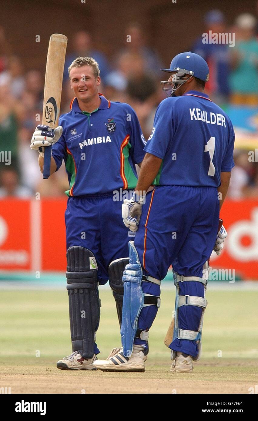 FOR EDITORIAL USE ONLY. NO COMMERCIAL USE: Namibia's Sarel Burger is congratulated by team mate Danie Keulder as he raises his bat after reaching 50 runs during their Cricket World Cup match against England at St George's Park, Port Elizabeth, South Africa. England won by 55 runs. Stock Photo