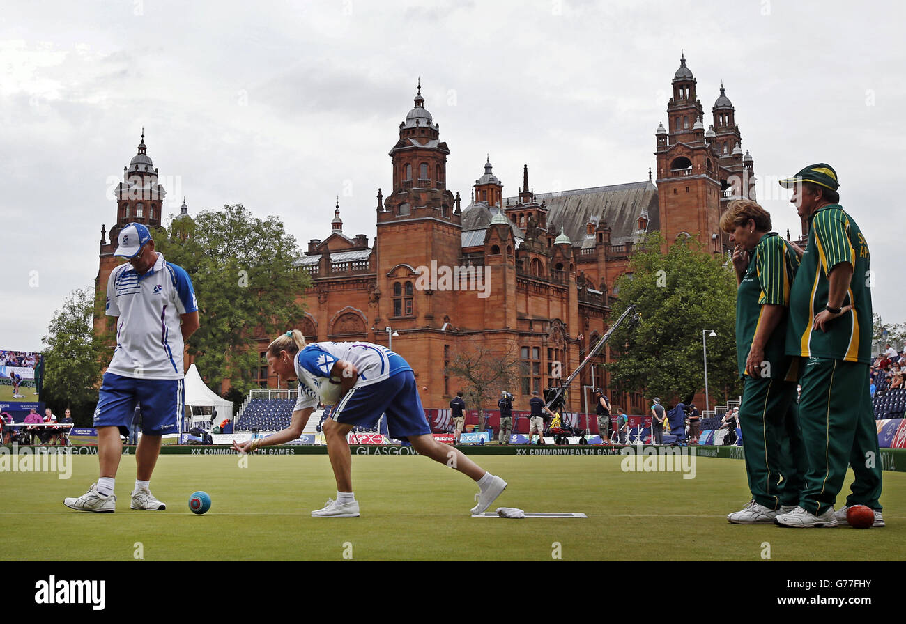 Scotland's Irene Edgar (second left) and David Thomas (left) with South Africa's Gwen Nel (third left and Geoff Newcombe (right) in the Para-Sports Mixed Pairs at Kelvingrove Lawn Bowls Centre during the 2014 Commonwealth Games in Glasgow. Stock Photo