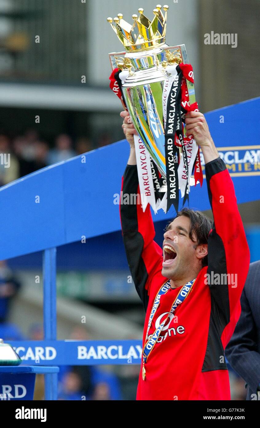 Manchester United's Ruud Van Nistelrooy holds the Premiership trophy