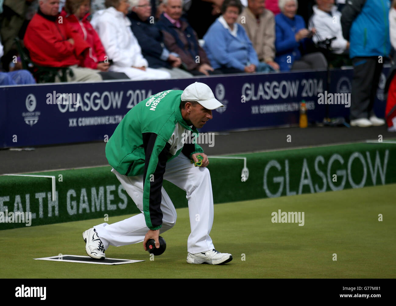 Northern Ireland's Martin McHugh plays a bowl during his Mens Singles quarter-final match against Scotland's Darren Burnett at Kelvingrove Lawn Bowls Centre, during the 2014 Commonwealth Games in Glasgow. Stock Photo