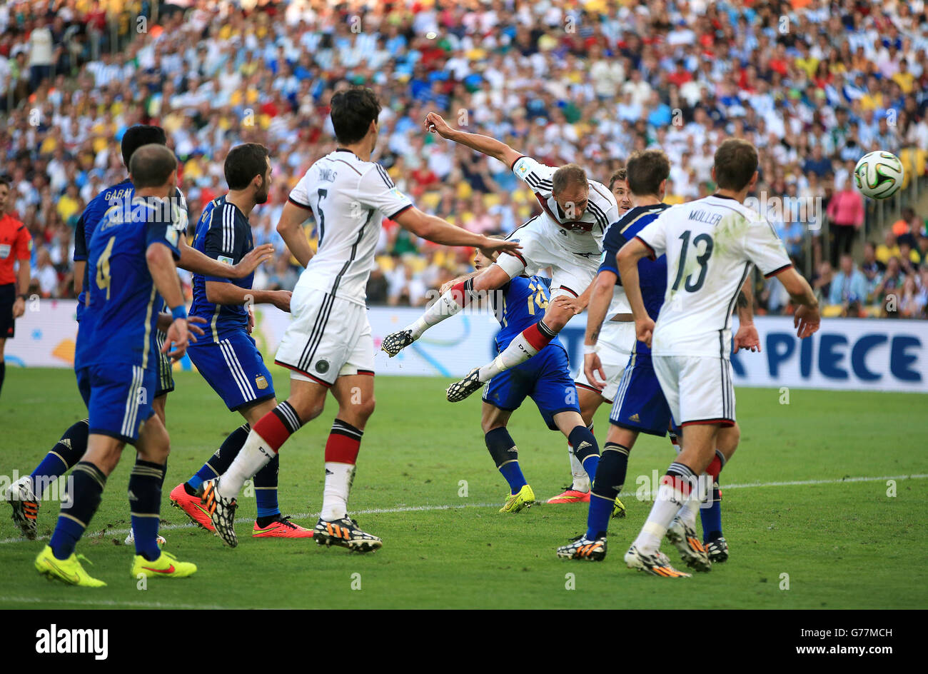 Soccer - FIFA World Cup 2014 - Final - Germany v Argentina - Estadio do Maracana. Germany's Benedikt Howedes (centre) with a headed effort on goal Stock Photo