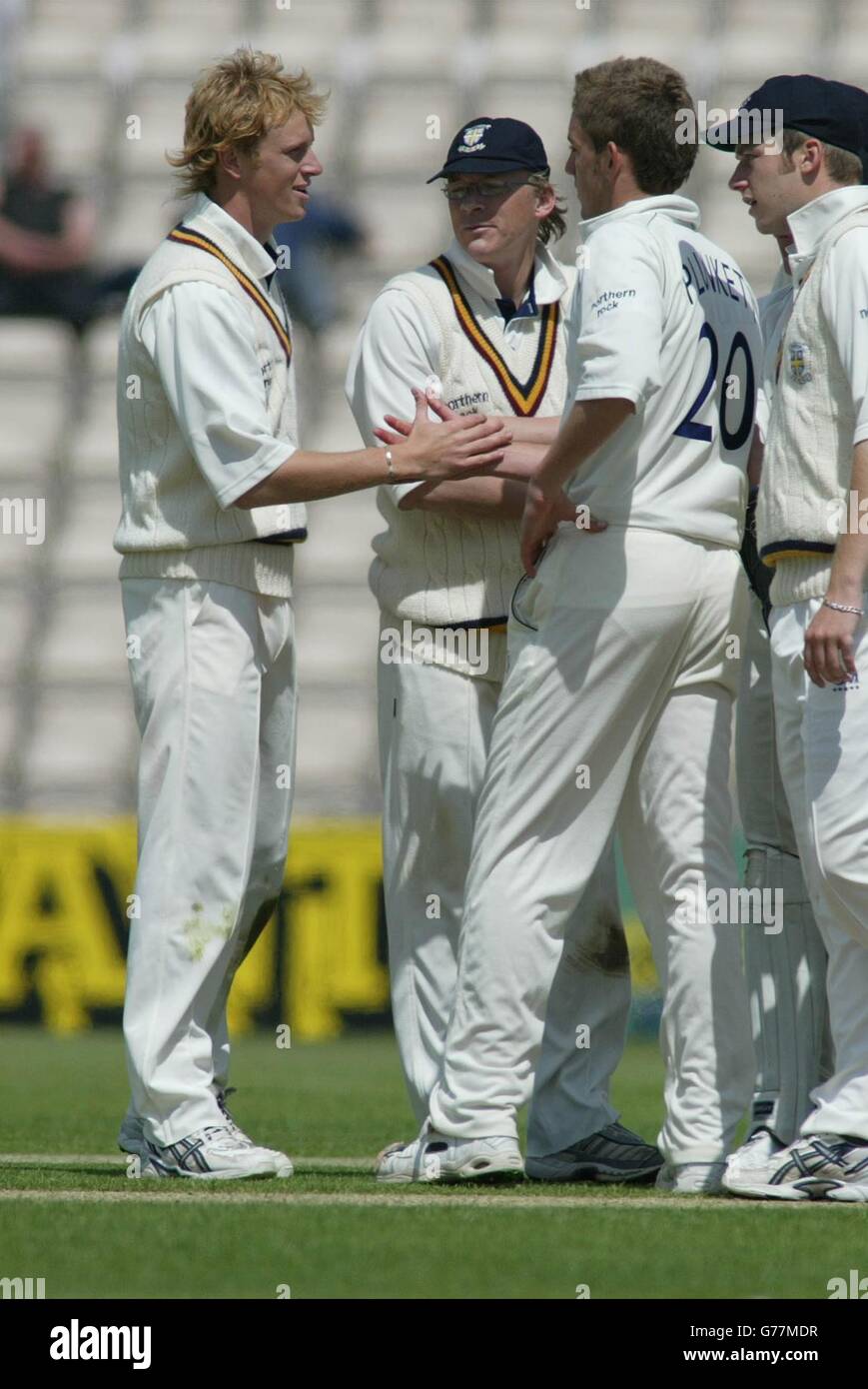 Durham bowler Liam Plunkett congratulates Mark Davies for taking the catch of Nic Pothas for 79 at the Rose Bowl near Southampton, on the second day of their Frizzell County Championship match. Stock Photo