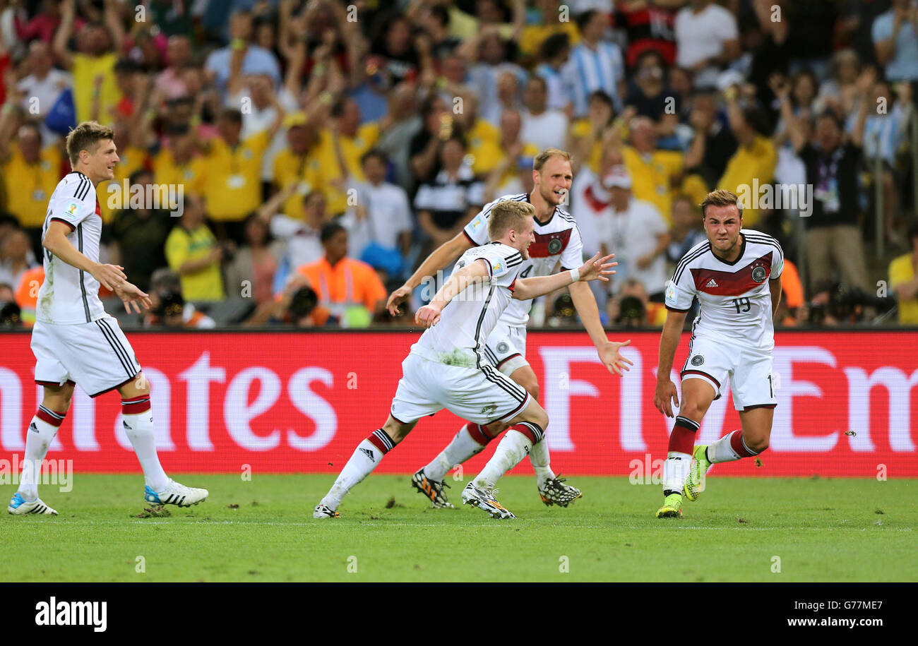 Germany's Mario Gotze (right) celebrates scoring the winning goal of the World Cup final with team-mates Andre Schurrle (centre) and Benedikt Howedes Stock Photo