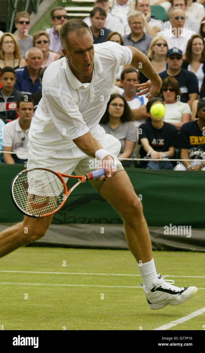 Todd Martin from the USA in action against Rainer Schuettler from Germany at the All England Lawn Tennis Championships in Wimbledon. Stock Photo