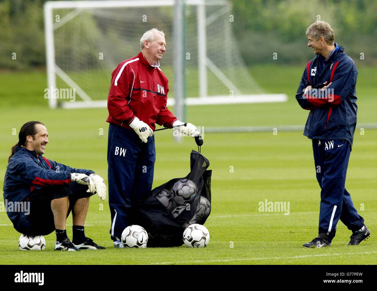 Arsenal manager Arsene Wenger (right) shares a joke with his goalkeeper David Seaman (left) and goalkeeping coach Bob Wilson (centre) during a training session at Arsenal's training ground, London Colney, Hertfordshire. Arsenal will play Auxerre in their Champions League Group A match tomorrow. Stock Photo