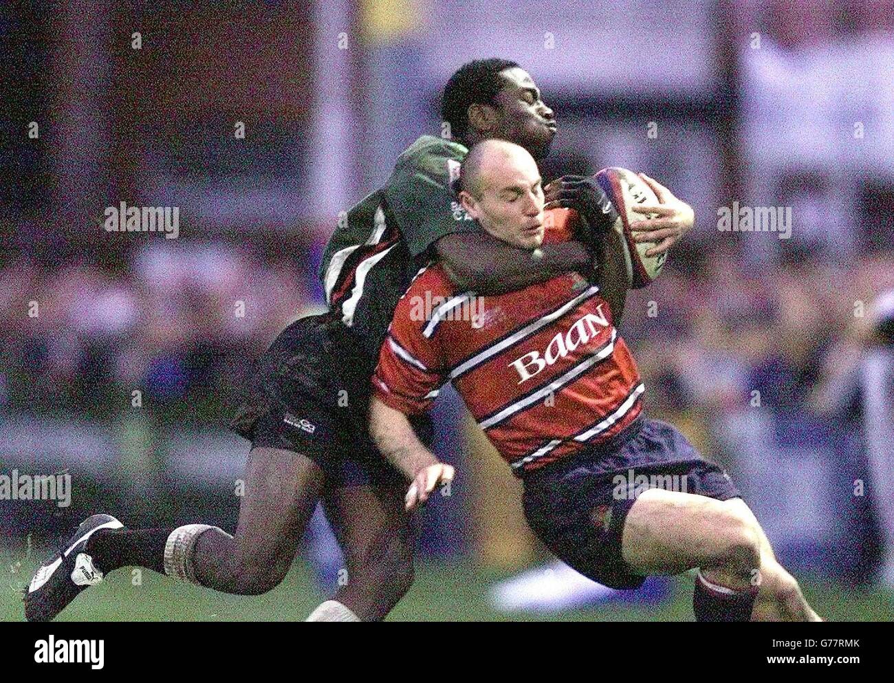 Gloucester's Ludovic Mercier (R) is tackled by Paul Sackey of London Irish during their Zurich Premiership match at Gloucester's Kingsholm stadium. Stock Photo