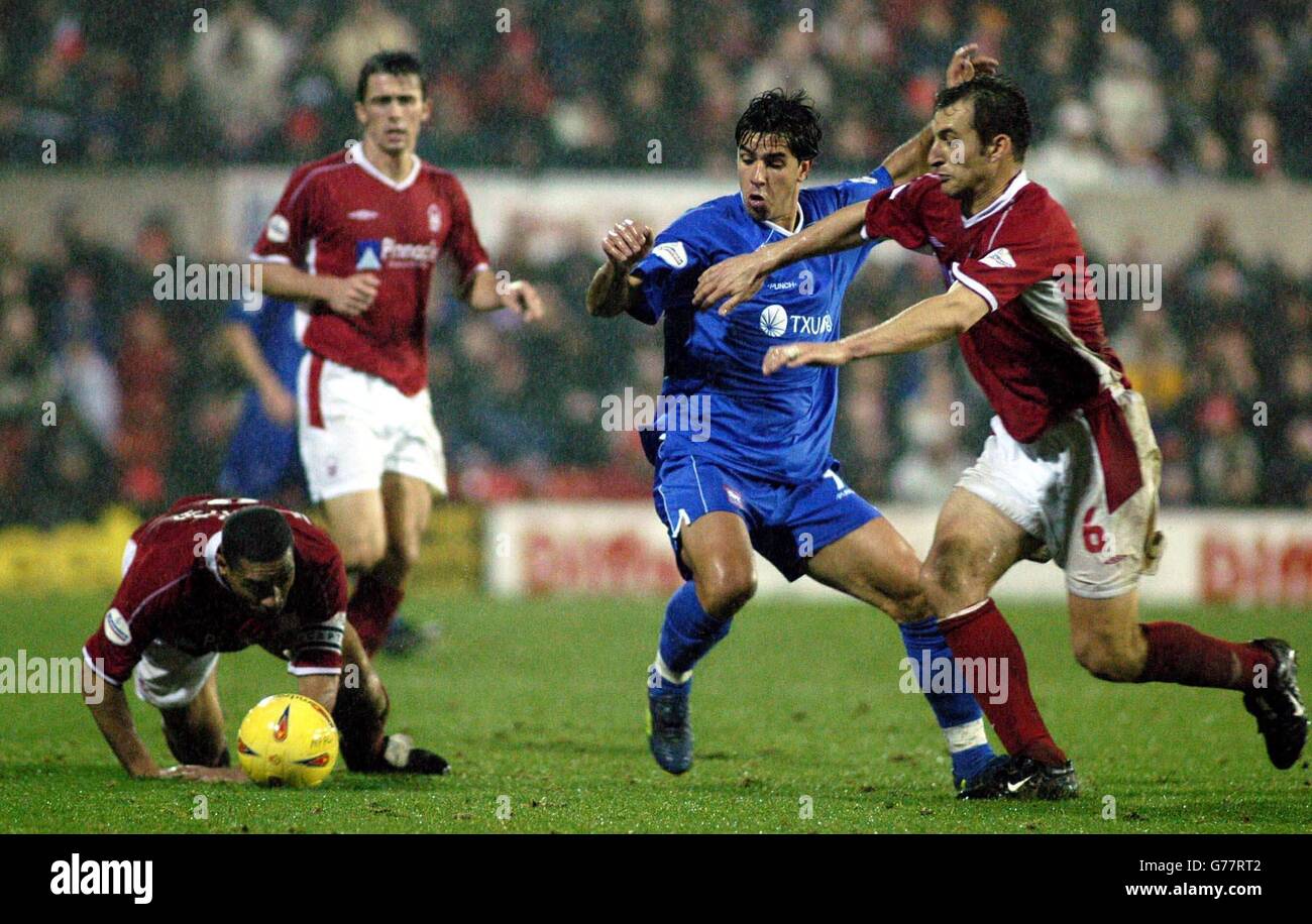 Nottingham Forest defender Ricardo Scimeca (right) battles with Ipswich Town striker Pablo Counago (2nd right) as Des Walker gets to his feet, during their Nationwide League Division One match at Forest's City Ground. (Final score 2-1) NO UNOFFICIAL CLUB WEBSITE USE. Stock Photo