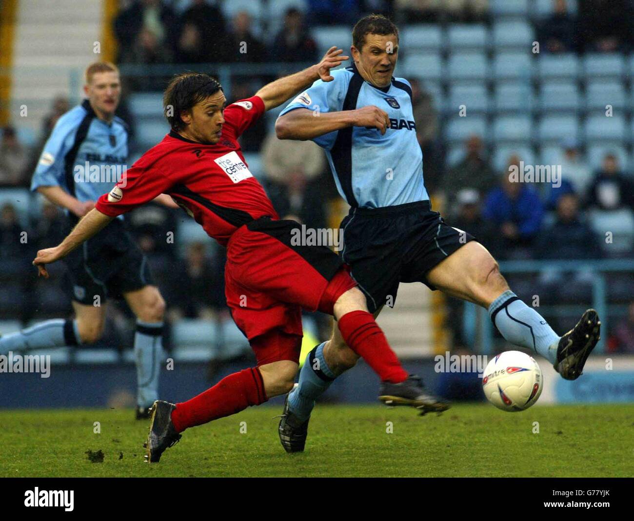 Wimbledon goal scorer, David Connolly (left) has another attempt under pressure from Coventry's John Eustace, during the Nationwide Division One match at The Highfield Road Stadium, Coventry. NO UNOFFICIAL CLUB WEBSITE USE. Stock Photo