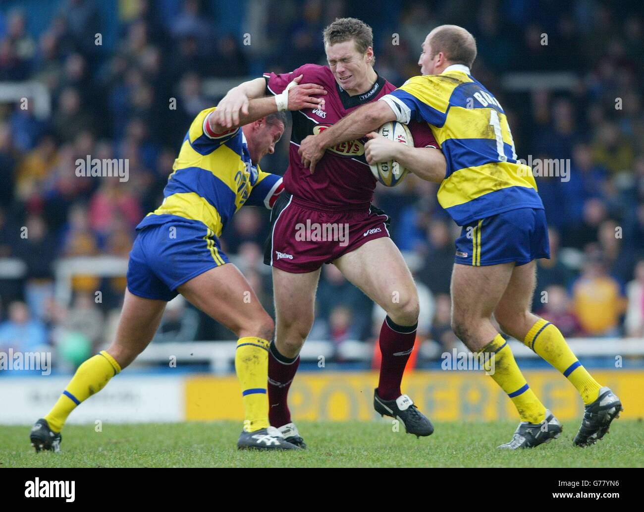 Leeds Rhinos Chris Feather is tackled by Warringon Wolves (L) Jon ...