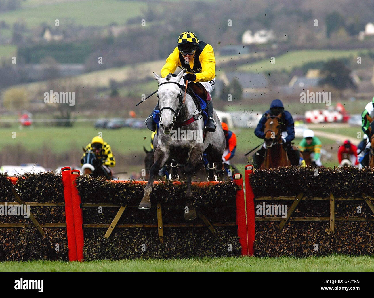 Rooster Booster with jockey Richard Johnson jumps the last to go on and win the Smurfit Champion Hurdle at Cheltenham. Stock Photo