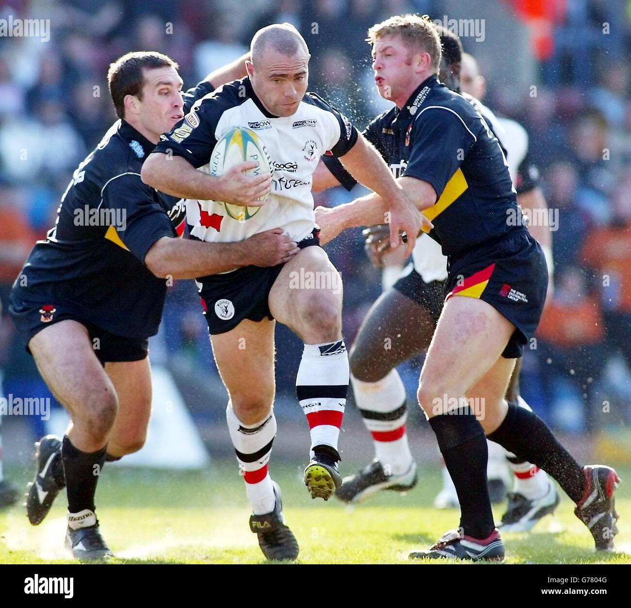 Widnes's Shane Millard gets through the tackles of Bradford's Daniel