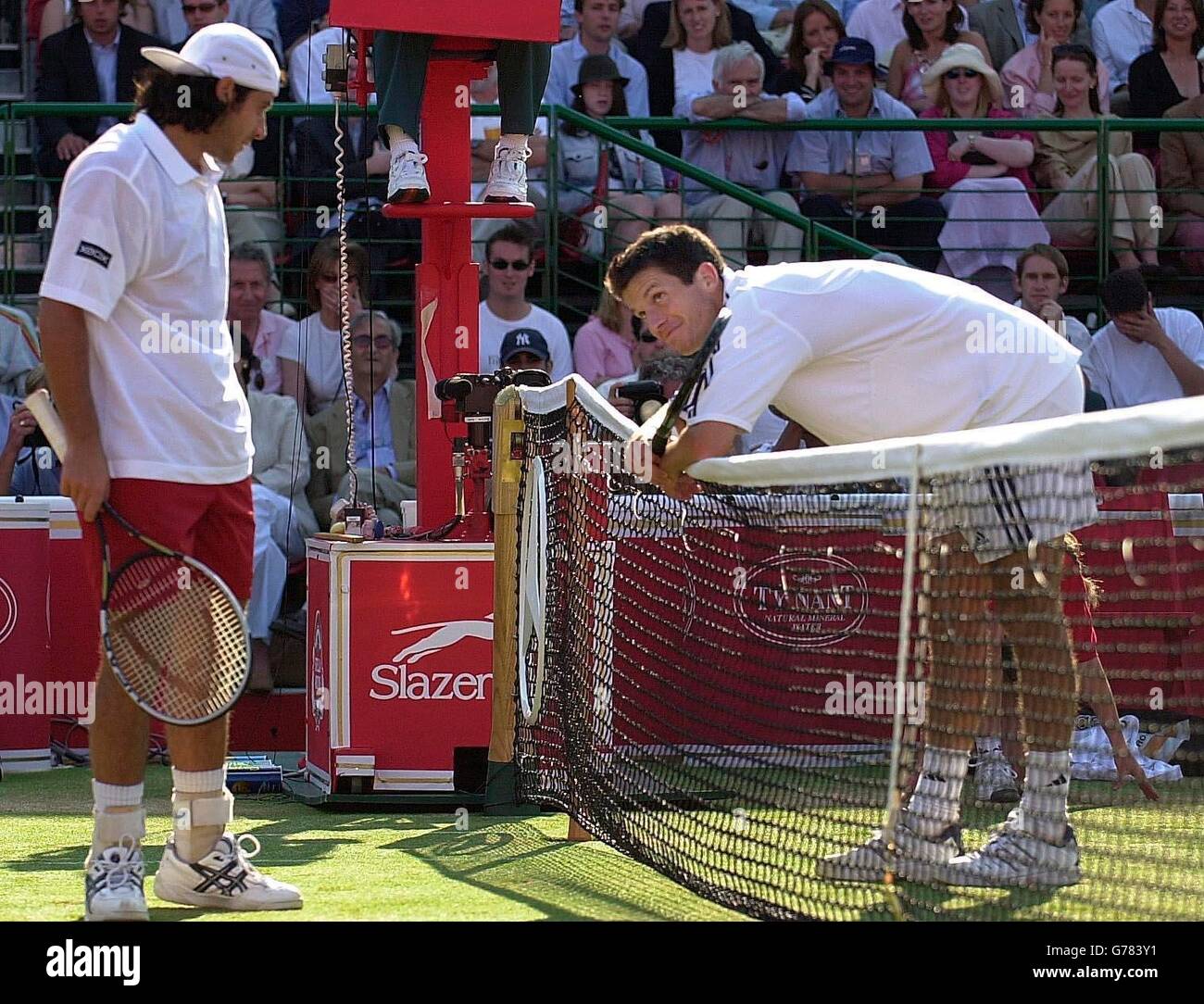 Great Britain's Tim Henman smiles at France's Sebastien Grosjean after a point during the semi-final of their match at the Stella Artois Championships, Queen's Club, London. Stock Photo