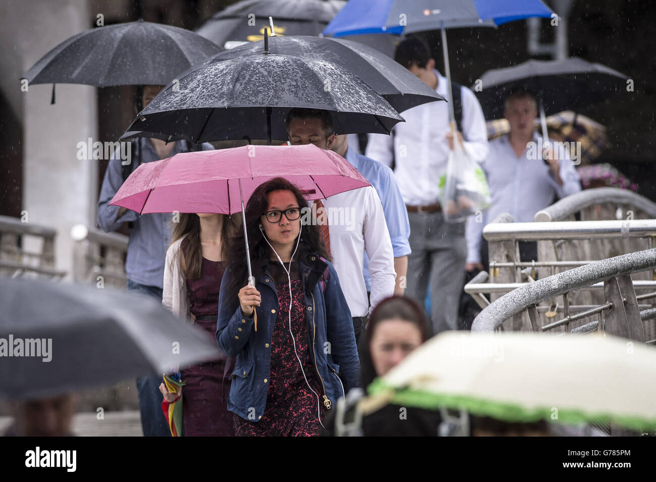 Commuters make their way to work in Bristol during wet weather. Stock Photo