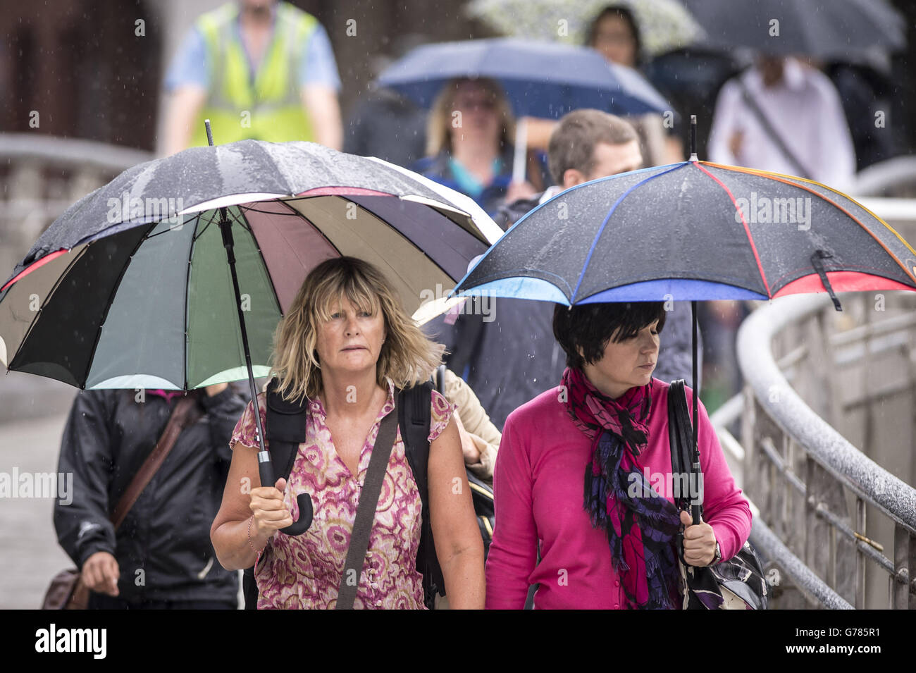 Commuters make their way to work in Bristol during wet weather. Stock Photo