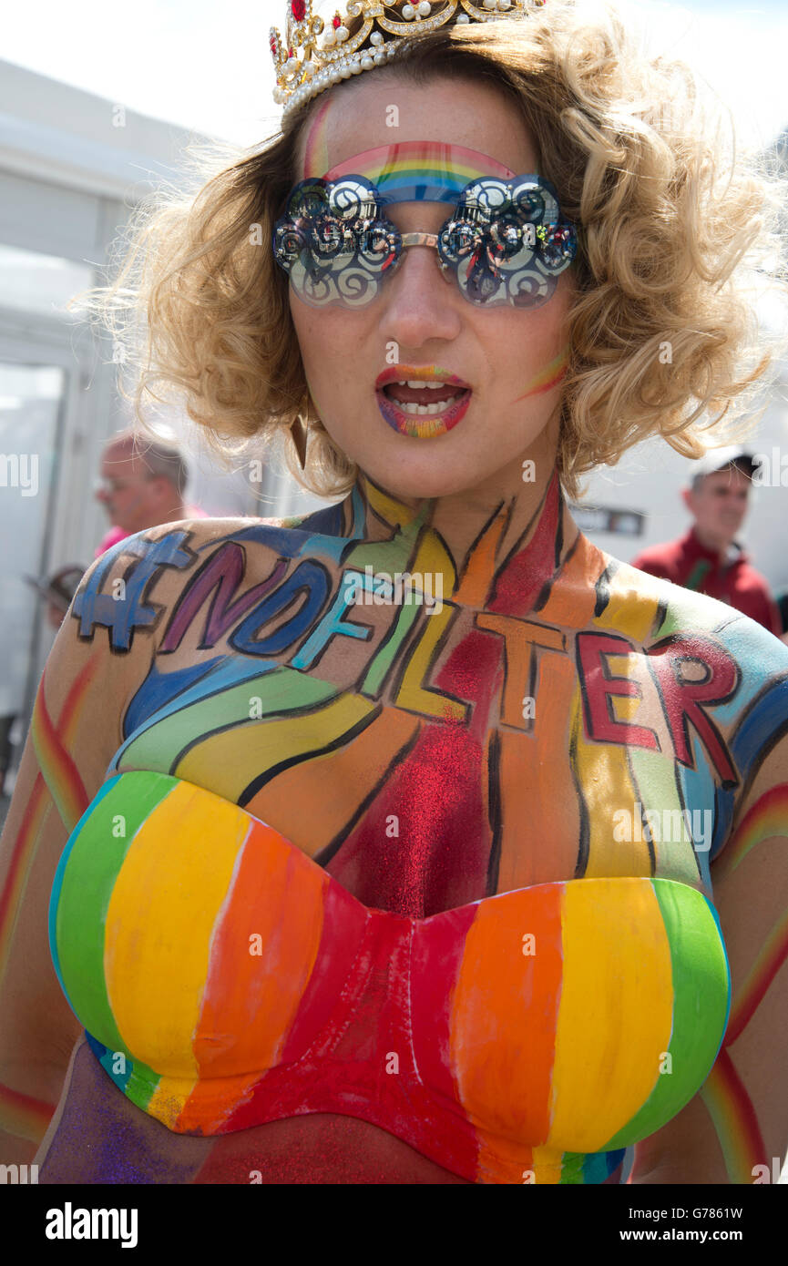 Pride in London 2016. Trafalgar Square. A woman with rainbow body paint and bikini top saying 'No filter' Stock Photo