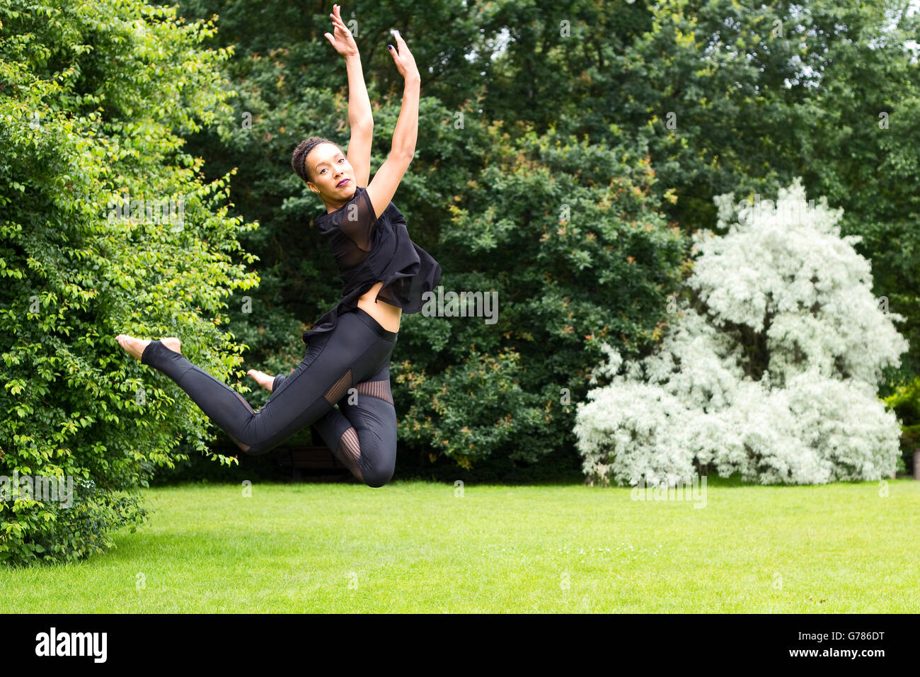 Jazz dancer performing a jump outdoors Stock Photo