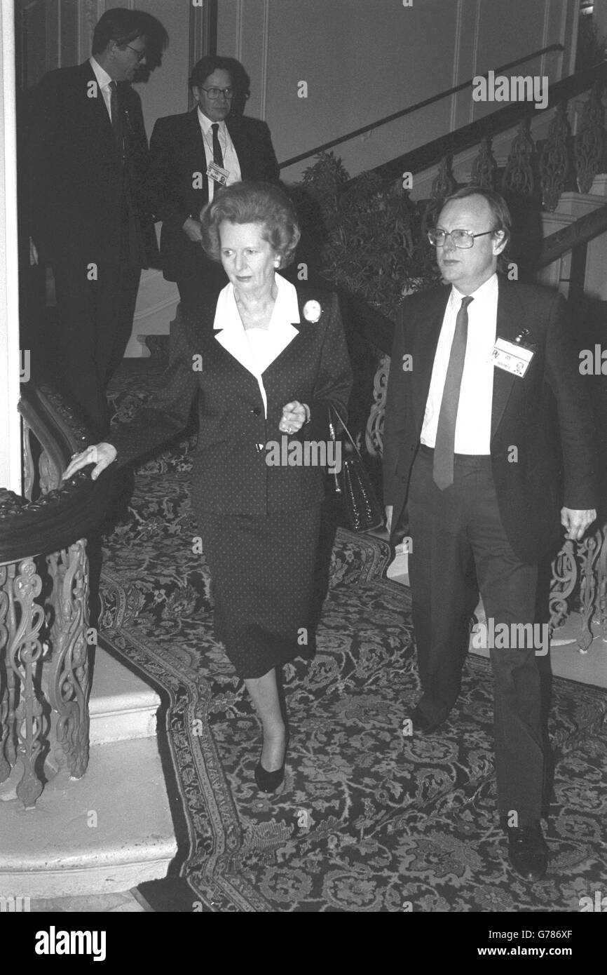 Prime Minister Margaret Thatcher walks down the staircase of the refurbished Grand Hotel in Brighton, accompanied by Agriculture Minister John Gummer, for the first Conservative Party Conference in Brighton since the IRA bombing in 1984. Stock Photo