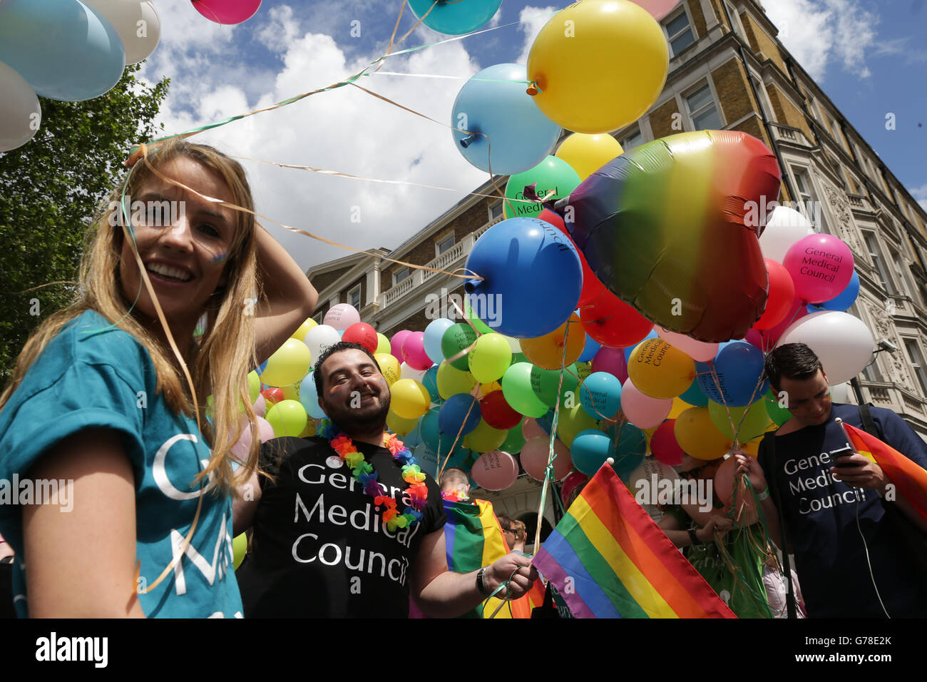 People holding balloons during the Pride in London parade, as it makes ...