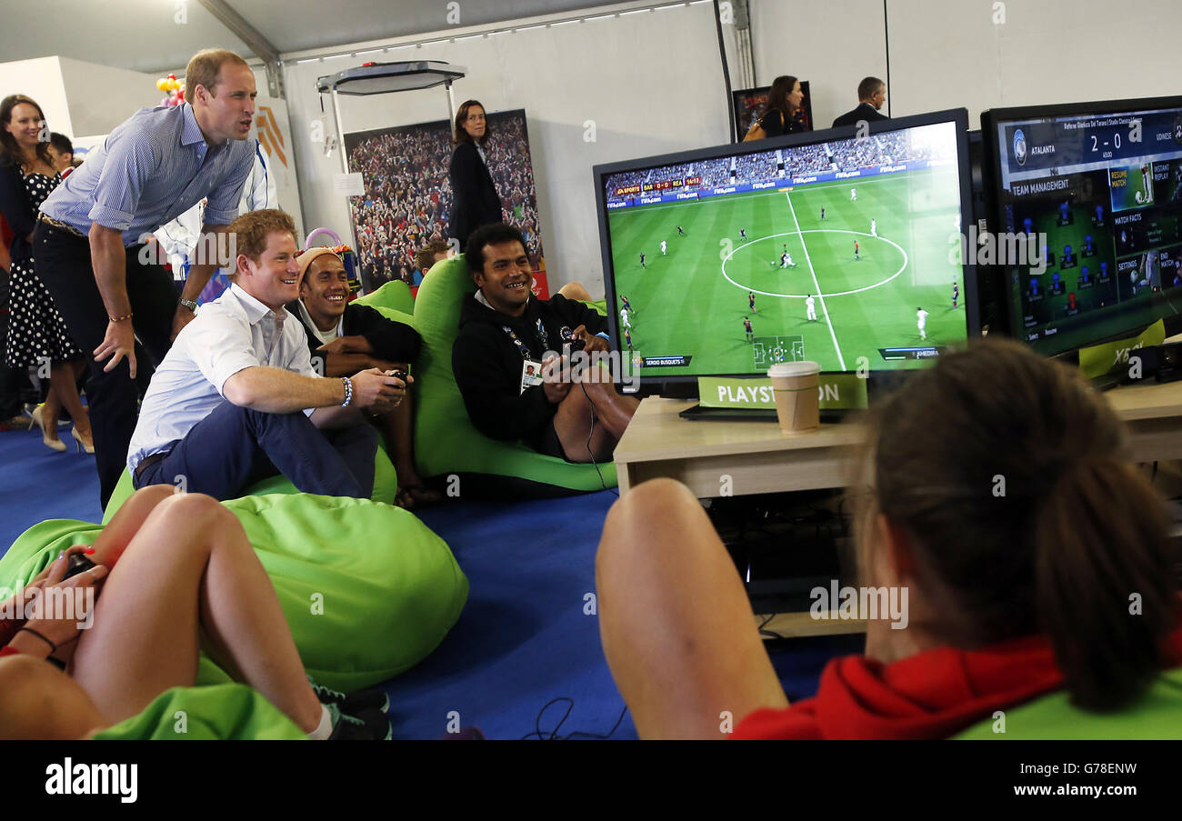 The Duke of Cambridge watches Prince Harry playing a video game during a  visit to the Commonwealth Games Village in Glasgow. P Stock Photo - Alamy