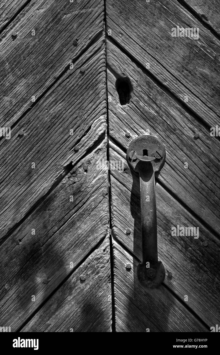 door latch on old unpainted wooden door Stock Photo