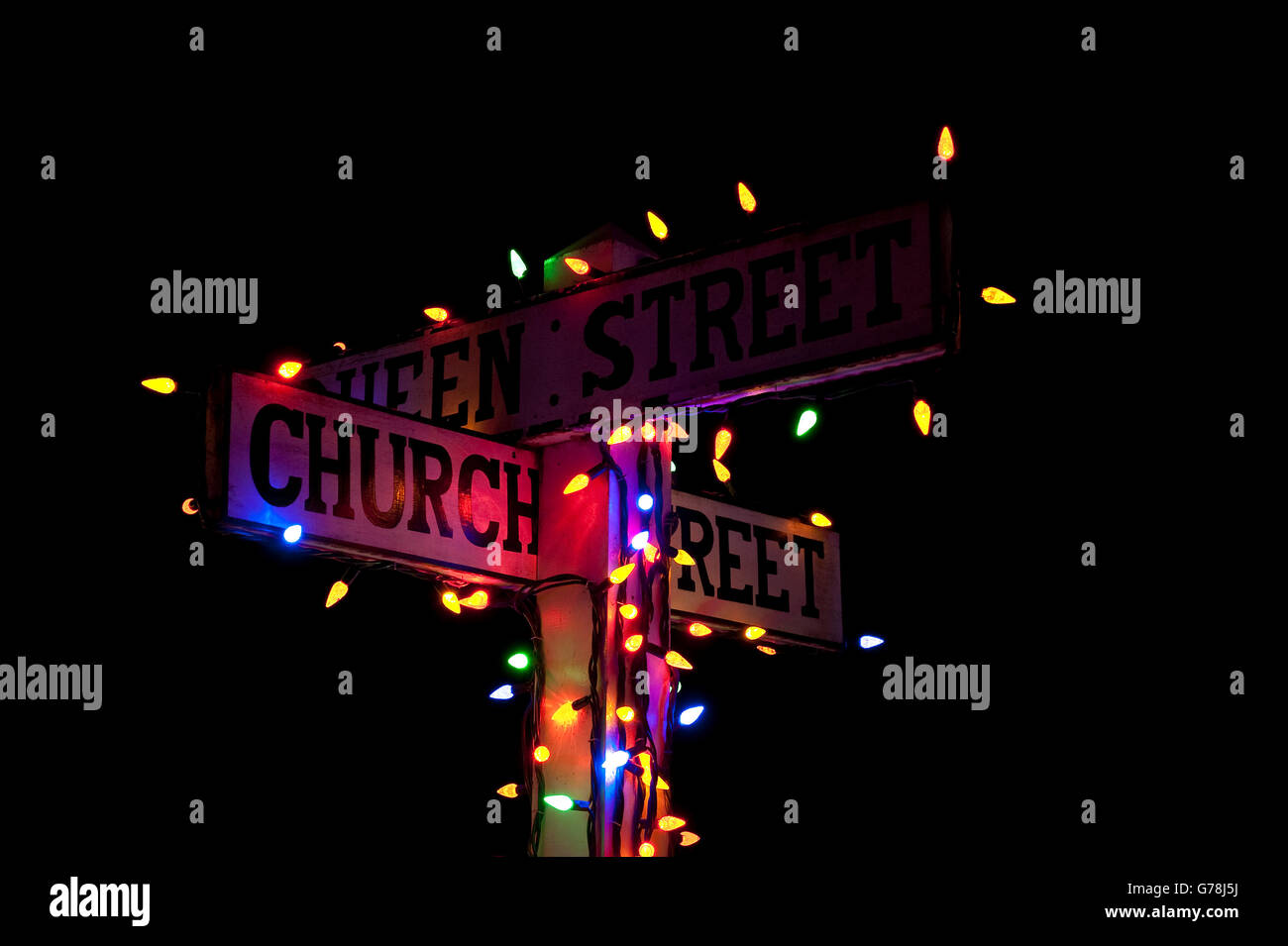 street signs decorated with colored lights for Christmas Stock Photo