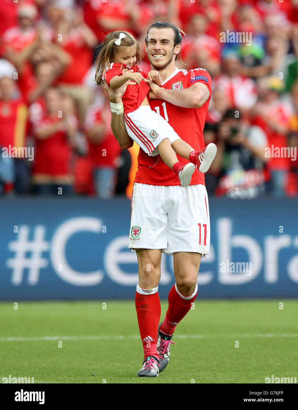 Wales' Gareth Bale celebrates with daughter Alba Violet on the pitch after  the round of 16 match at the Parc de Princes, Paris Stock Photo - Alamy