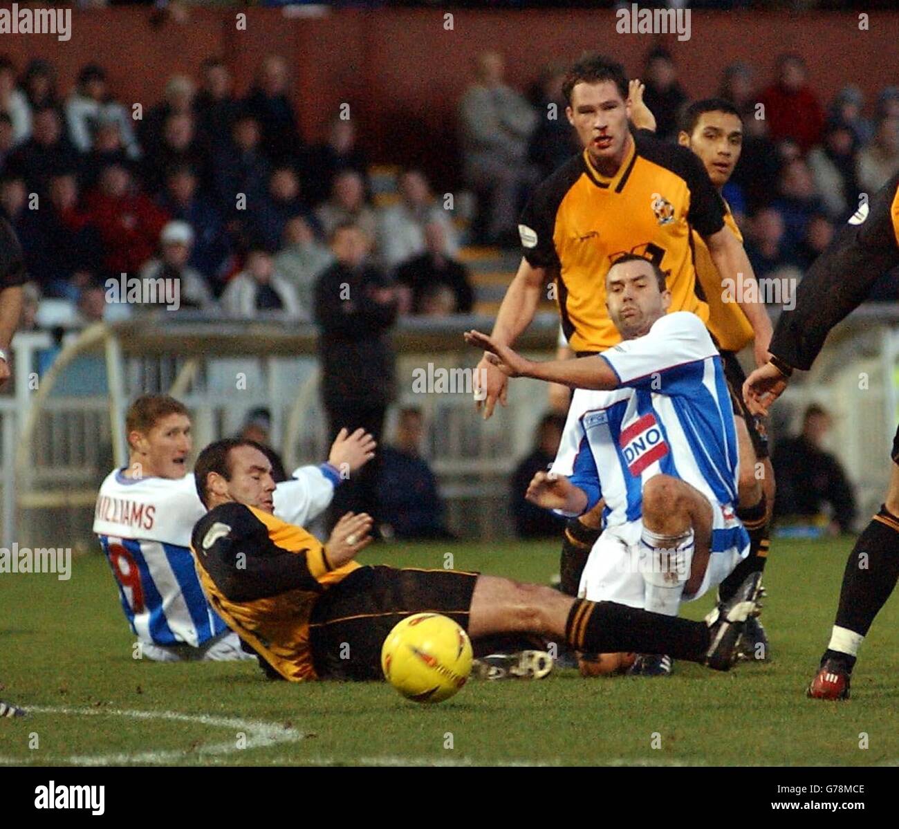 Hartlepool's Tommy Widdrington slides the ball past Cambridge United's Shane Tudor during their Nationwide Division Three match at Hartlepool's Victoria Park ground. . Stock Photo