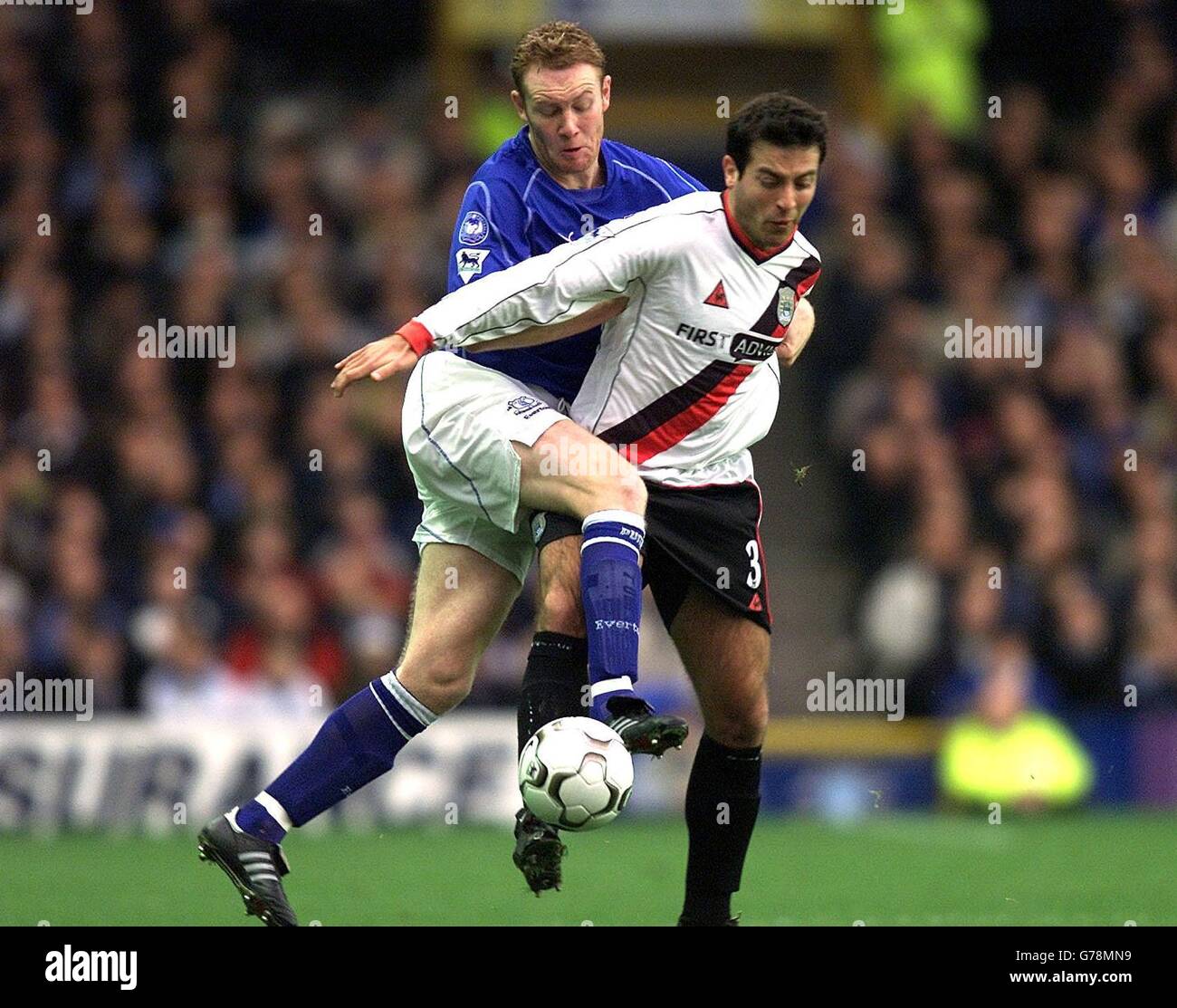 Manchester City's Niclas Jensen is challenged by Everton's Steve Watson, during the FA Barclaycard Premiership match at Goodison Park, Liverpool. Stock Photo