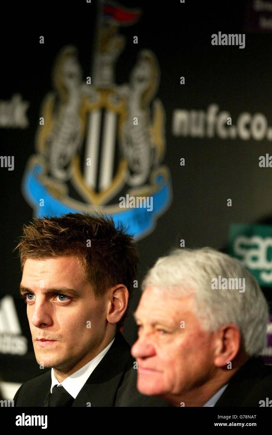 Newcastle United's new signing Jonathan Woodgate with manager Sir Bobby Robson (R) at a press conference at the club's St James' Park ground, following his 9m signing from Leeds United. Stock Photo