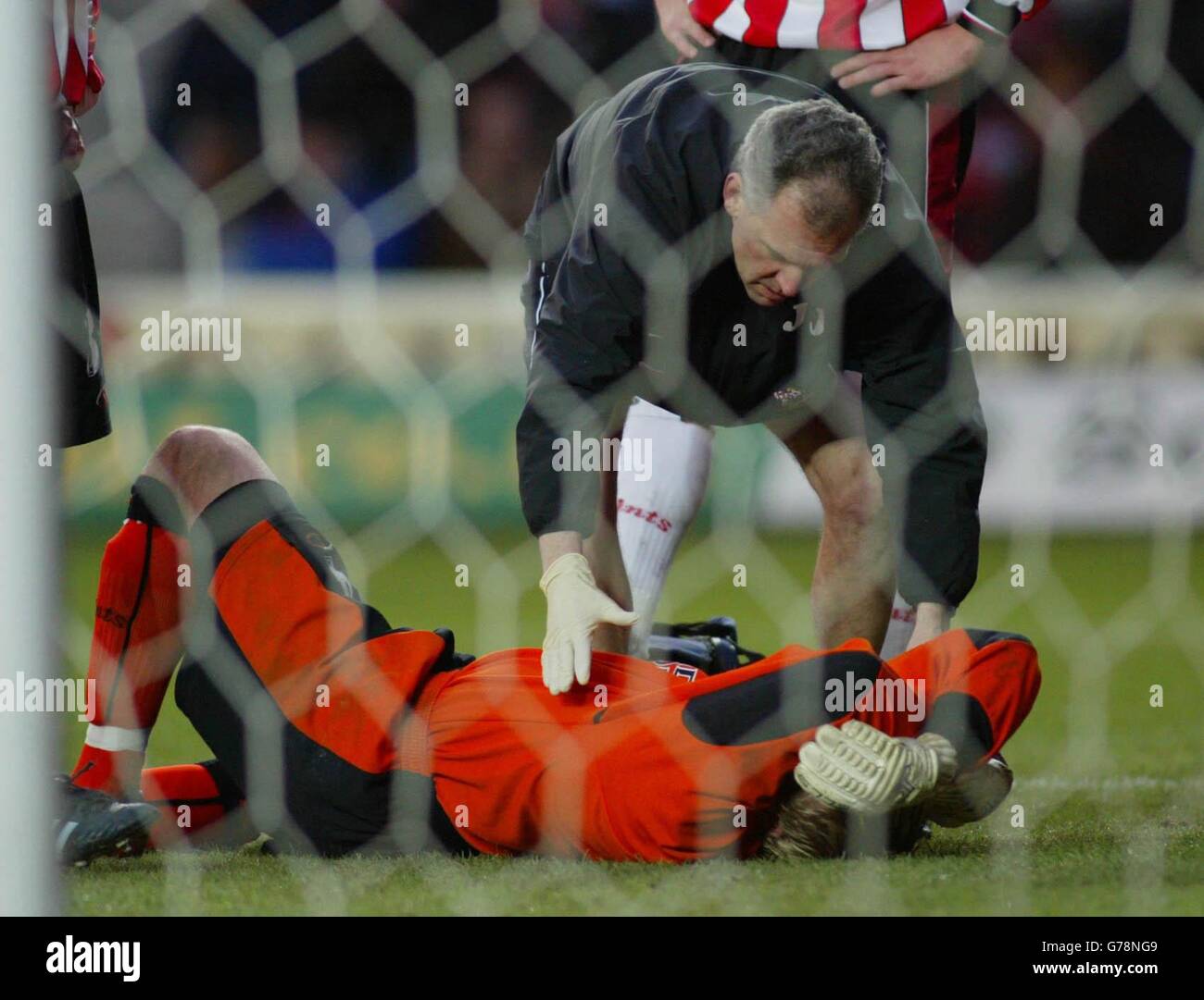 Southampton goalkeeper Antti Niemi lies prostate after a clash with Ruud Van Nistelrooy of Manchester United during their FA Barclaycard Premiership match at Southampton's St Mary's Stadium. Final score Southampton 0 Man Utd 2. Stock Photo
