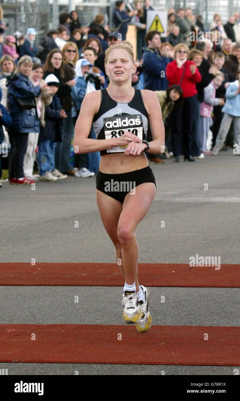 First female winner Amy Stiles (No 8949) finishing at 1 hr 15. 11, at rhe  adidas Flora London Half Marathon at Silverstone Grand Prix race circuit in  Northamptonshire Stock Photo - Alamy