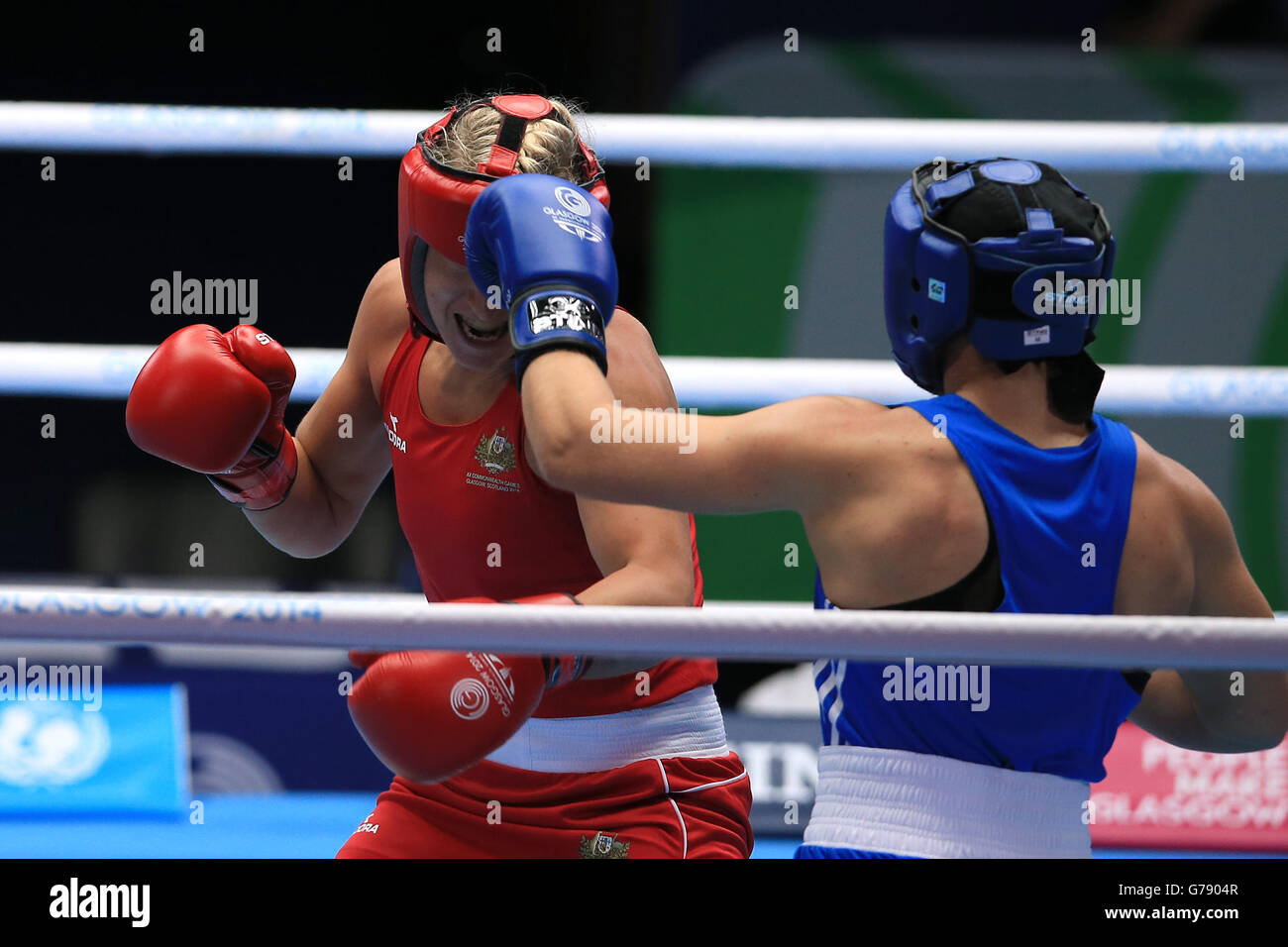 Wales' Lauren Price in action against Australia's Kaye Scott (left) in the Women's Middle Quarter-final at the SECC, during the 2014 Commonwealth Games in Glasgow. PRESS ASSOCIATION Photo. Picture date: Wednesday July 30, 2014. See PA story COMMONWEALTH Boxing. Photo credit should read: Peter Byrne/PA Wire. Stock Photo