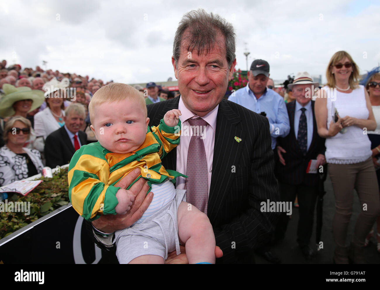 JP McManus celebrates with 6 month old Conor Jordan from Navan after Thomas  Edison's victory in The Guinness Galway Hurdle Handicap on day four of the  Galway Festival at Galway Racecourse, Ireland