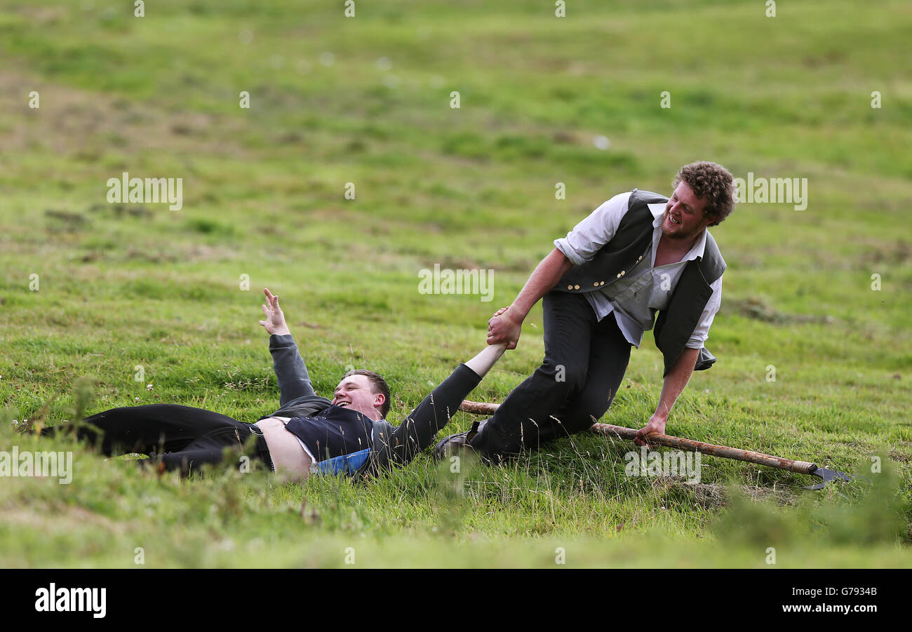 An Irish rebel drags an injured comrade to safety during the Vinegar Hill Battle Re-enactment at Enniscorthy, Co Wexford, Ireland. Stock Photo