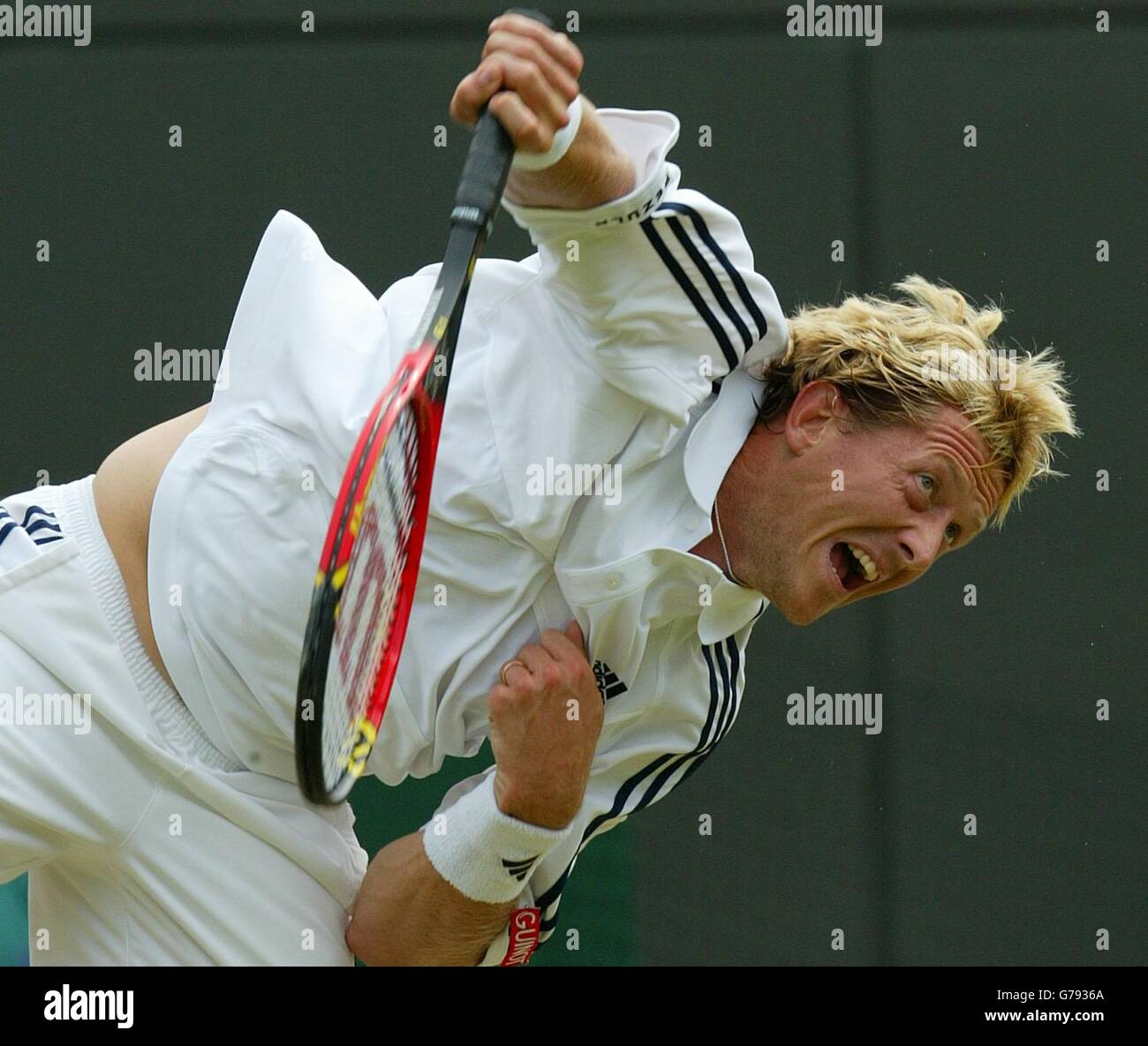 , NO MOBILE PHONE USE. Jonas Bjorkman from Sweden in action against Andy Roddick from the USA during their quarter-final match at the All England Lawn Tennis Championships at Wimbledon. Stock Photo
