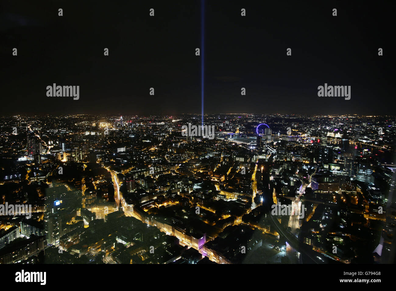 A west facing View from The Shard of the light installation spectra, by Japanese artist Ryoji Ikeda, projecting up into the night sky from Victoria Tower Gardens in London. Stock Photo