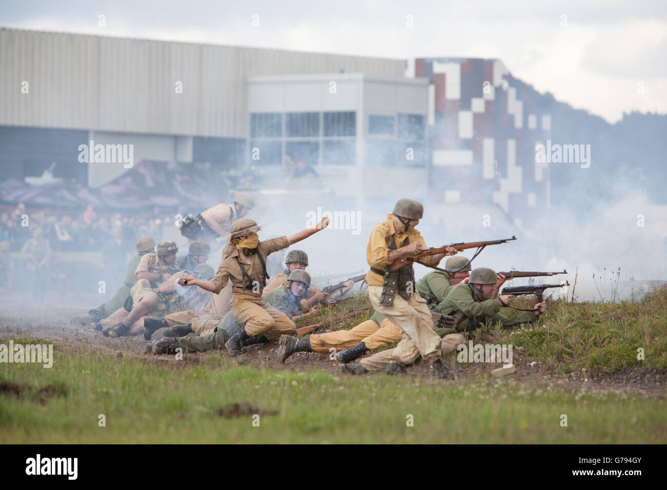 Bovington, Dorset, UK. 25th June 2016. Tankfest military show. Finale - German troops attacking Americans. Story line re-enacts how the Tiger 1 at the museum was captured. Crowd and museum buildings in background. Credit:  Colin C. Hill/Alamy Live News Stock Photo
