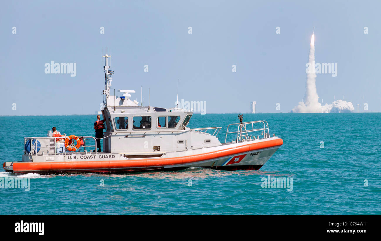 Orlando, Florida, USA. 24th June, 2016. A U.S. Coast Guard patrol boat provides security as the  United Launch Alliance Atlas V rocket carrying the MUOS-5 mission lifts off from Space Launch Complex June 24, 2016 in Cape Canaveral, Florida. Credit:  Planetpix/Alamy Live News Stock Photo